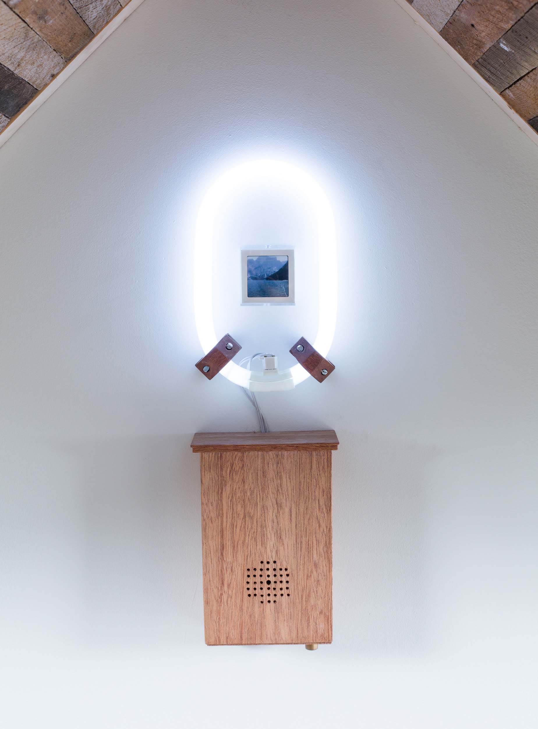 Mark Baugh-Sasaki, (Detail) Uncanny Valley Color 35mm slide, Plexiglas, electronics, fluorescent light, speaker, audio recording, plywood, lath, roofing shingles 36” x 72” x 36” 2019